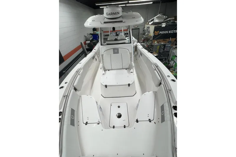 Slide: The Image of 2024 Sea Fox 288 Commander boat interior with Garmin equipment in a workshop setting. - 8