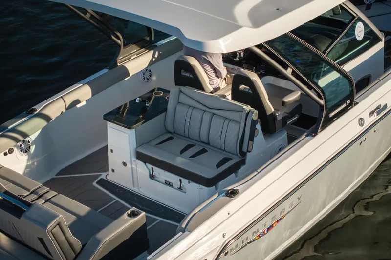 Slide: The Image of 2026 Monterey Elite 30 OB boat interior with luxurious seating and sleek design. - 11