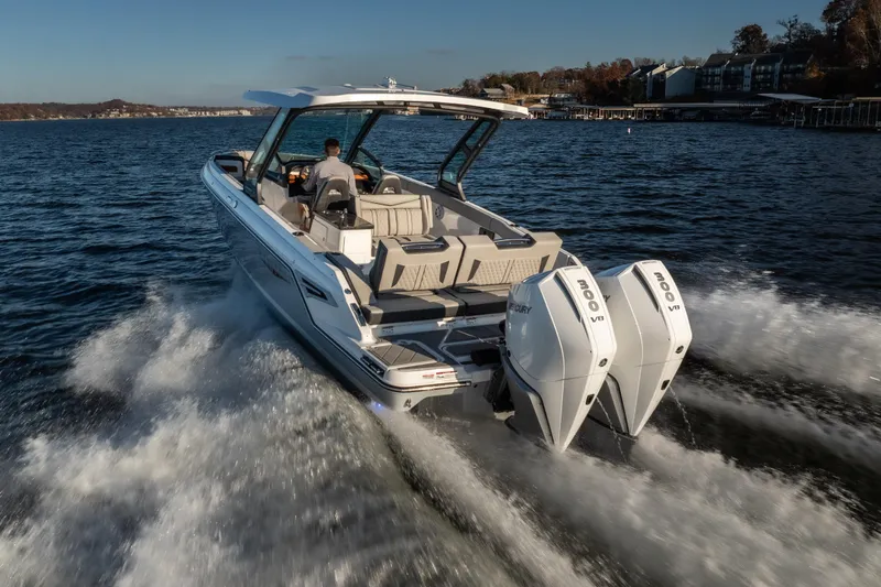 Slide: The Image of 2026 Monterey Elite 30 OB cruising on a lake with dual Mercury V8 engines. - 14