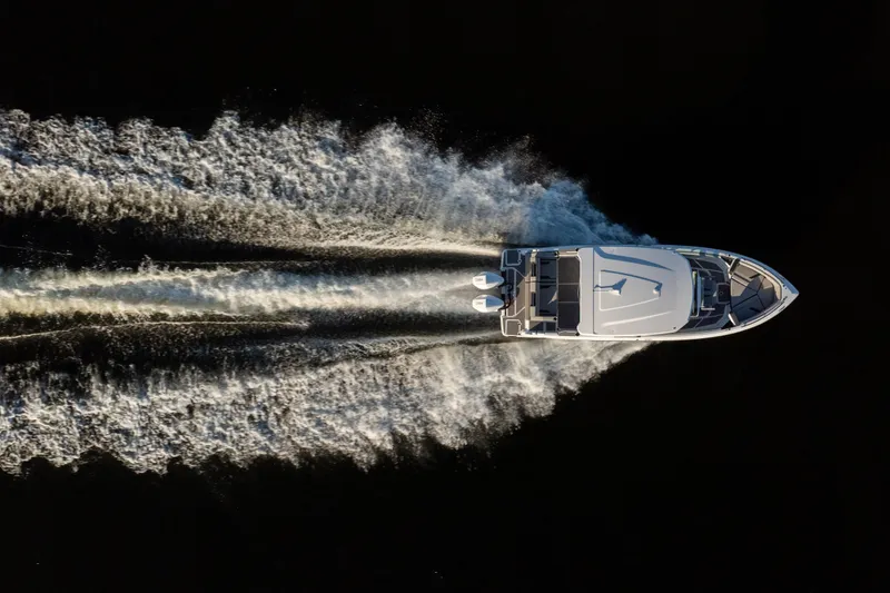 Slide: The Image of Aerial view of 2026 Monterey Elite 30 OB boat cruising on water. - 18