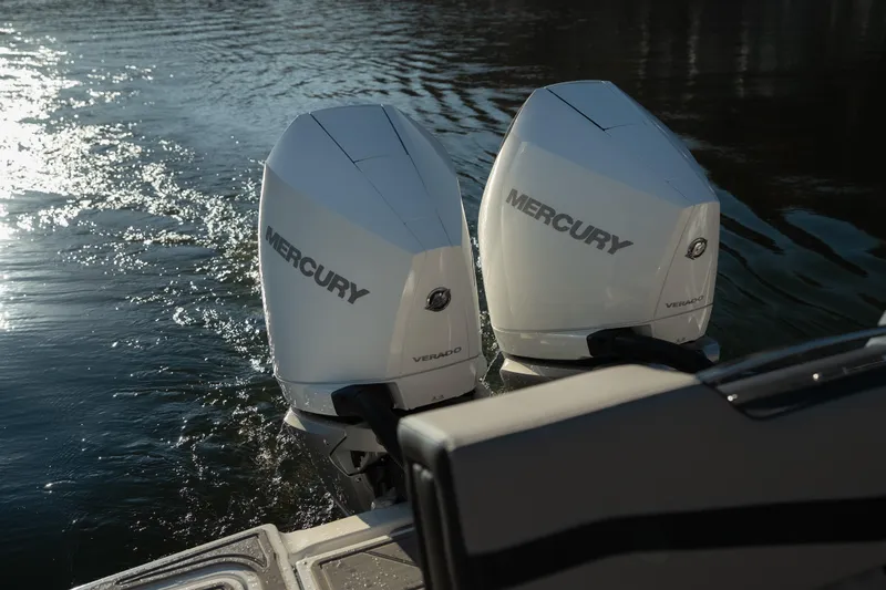 Slide: The Image of Twin Mercury outboard engines on a 2026 Monterey Elite 30 OB boat in water. - 20