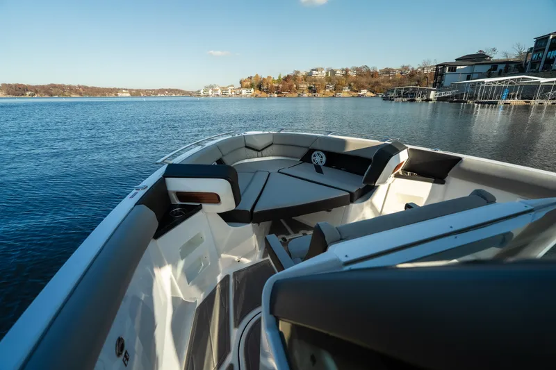 Slide: The Image of 2026 Monterey Elite 30 OB boat interior with lake view and modern seating. - 22