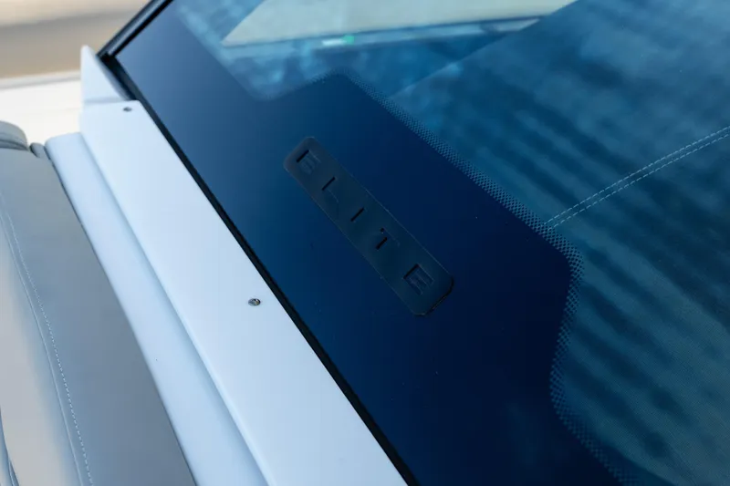 Slide: The Image of Close-up of 2026 Monterey Elite 30 OB boat windshield with "Elite" branding. - 23