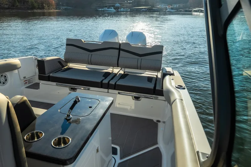 Slide: The Image of 2026 Monterey Elite 30 OB boat interior with seating and water view. - 24