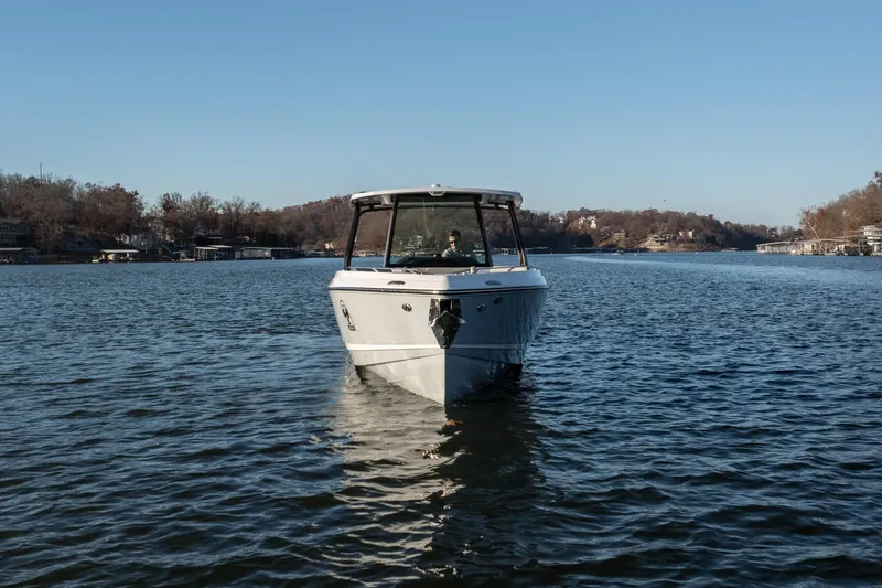 Slide: The Image of 2026 Monterey Elite 30 OB boat cruising on a serene lake under a clear blue sky. - 3