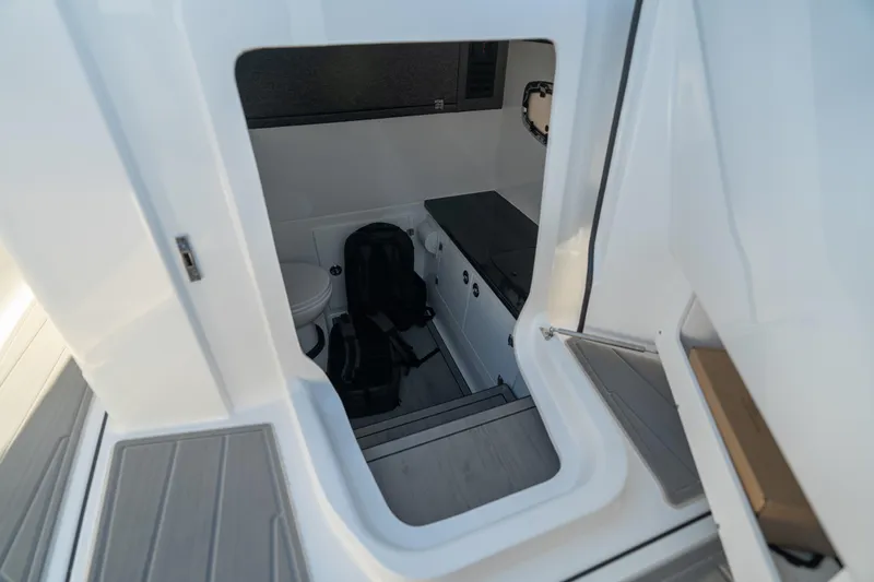 Slide: The Image of Interior cabin view of 2026 Monterey Elite 30 OB boat, featuring modern amenities. - 30