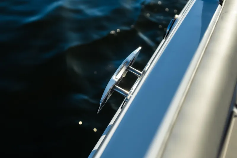 Slide: The Image of Close-up of 2026 Monterey Elite 30 OB boat cleat against water background. - 32