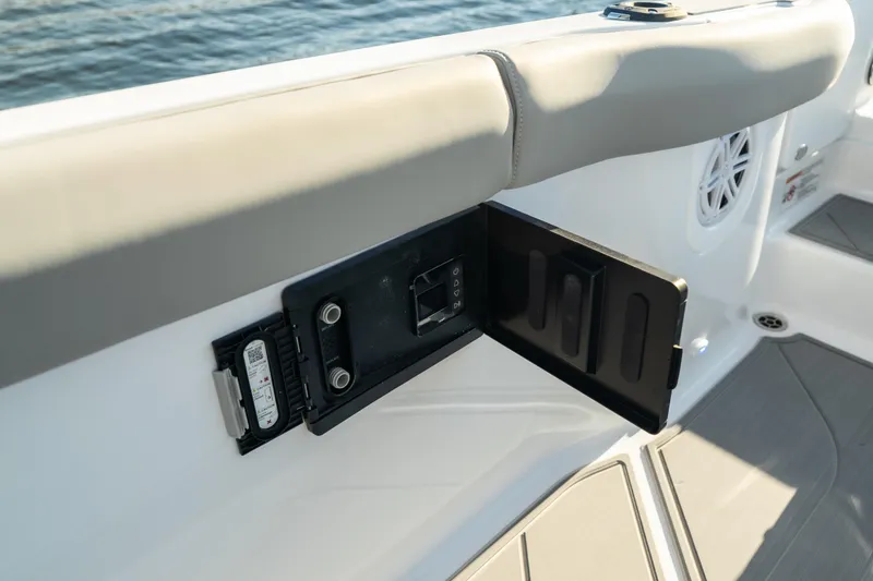 Slide: The Image of 2026 Monterey Elite 30 OB boat interior with open control panel by the water. - 33