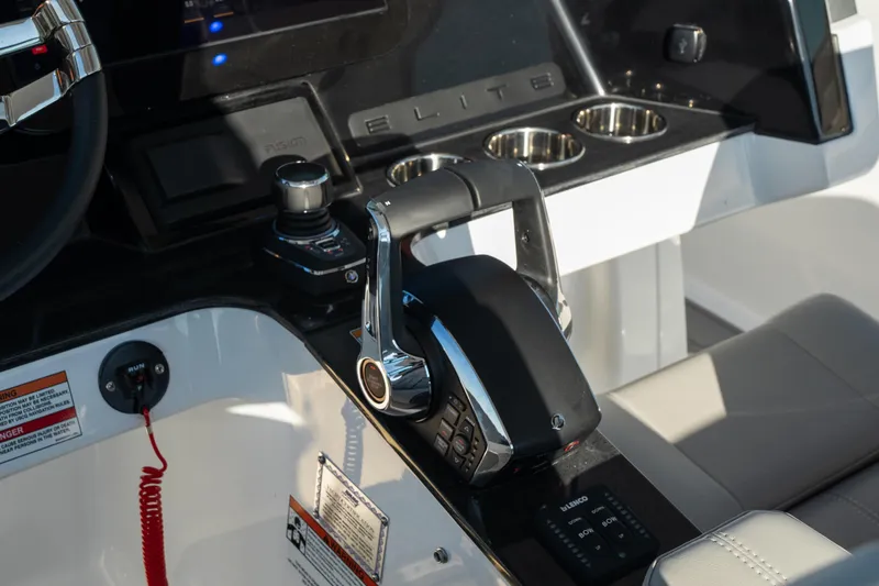 Slide: The Image of 2026 Monterey Elite 30 OB boat dashboard with controls and cup holders. - 36