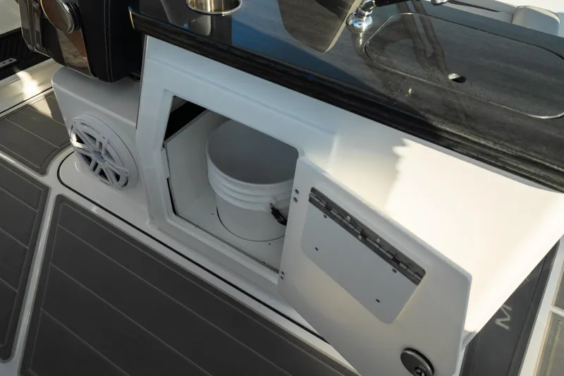 Slide: The Image of 2026 Monterey Elite 30 OB boat interior with storage compartment and bucket. - 42