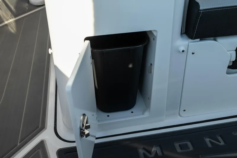 Slide: The Image of Storage compartment with trash bin on 2026 Monterey Elite 30 OB boat. - 43