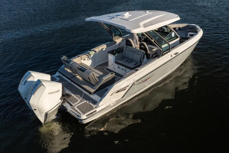 Slide: The Image of 2026 Monterey Elite 30 OB boat cruising on water, featuring sleek design and powerful Mercury engines. - 8