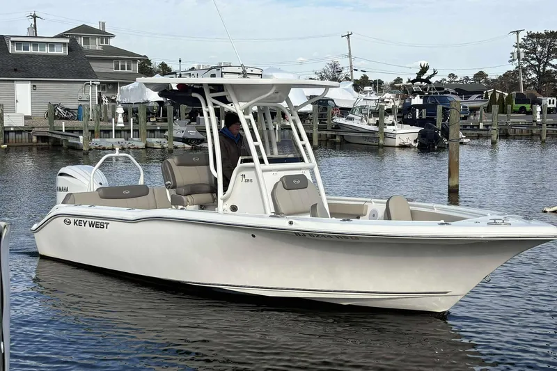 The Image of 2024 Key West 239 FS boat docked in a marina, featuring sleek design and Yamaha engine. - 1