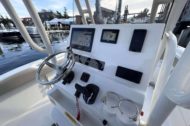 Slide: The Image of 2024 Key West 239 FS boat dashboard with steering wheel and electronic displays. - 10
