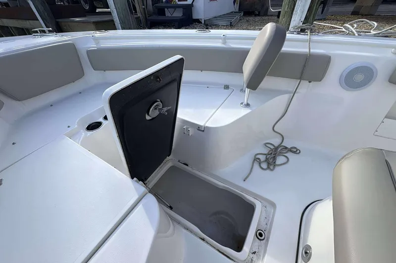 Slide: The Image of 2024 Key West 239 FS boat interior with open storage compartment and seating. - 14