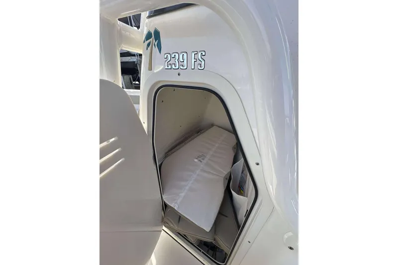 Slide: The Image of 2024 Key West 239 FS boat storage compartment with visible interior details. - 17