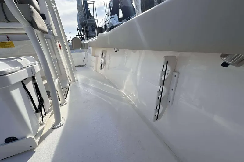Slide: The Image of 2024 Key West 239 FS boat interior, showcasing sleek white deck and seating area. - 18
