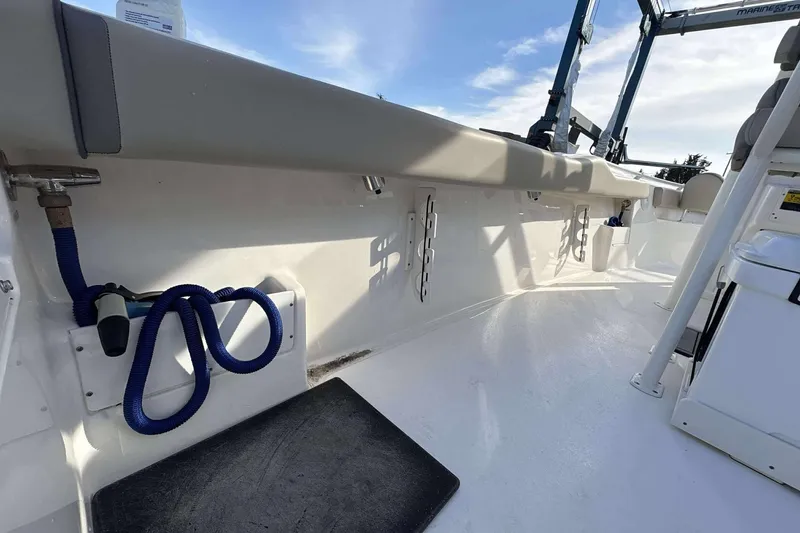 Slide: The Image of 2024 Key West 239 FS boat interior with seating and storage features. - 19