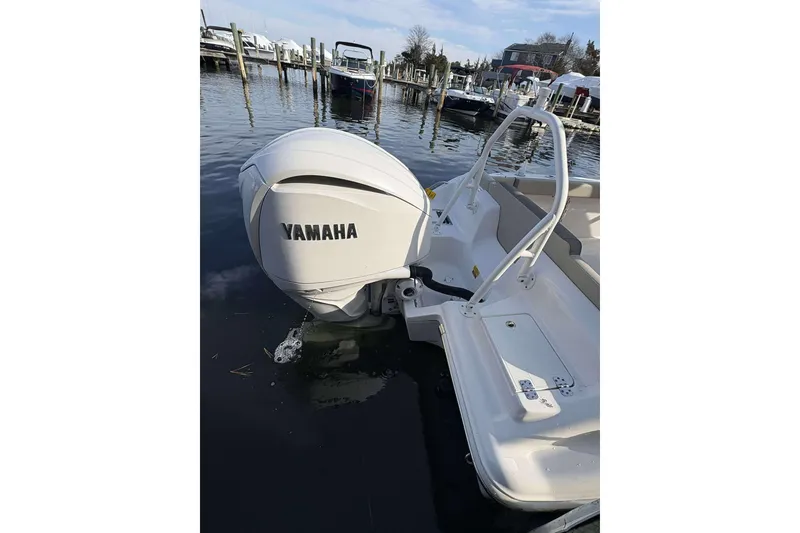 Slide: The Image of 2024 Key West 239 FS boat with Yamaha outboard engine docked at marina. - 21