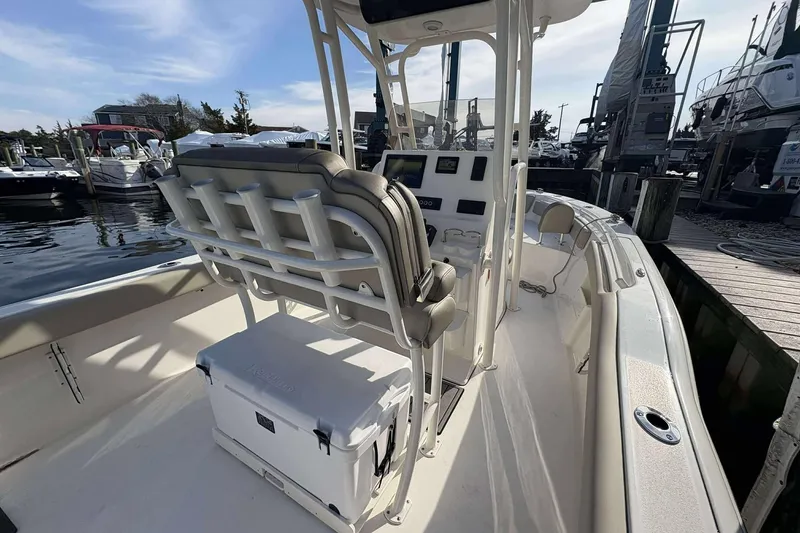 Slide: The Image of 2024 Key West 239 FS boat interior with seating and control panel at marina. - 4