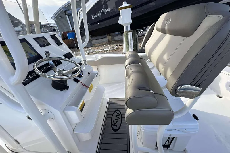 Slide: The Image of 2024 Key West 239 FS boat interior with steering wheel and seating. - 5