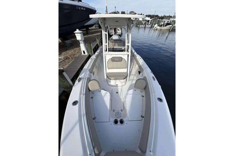 Slide: The Image of 2024 Key West 239 FS boat docked, showcasing spacious seating and sleek design. - 9