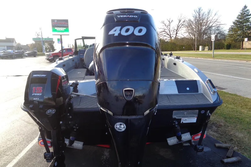 Slide: The Image of 2022 Vexus DVX22 boat with Mercury 400 and 15 Pro outboard engines, parked outdoors. - 16