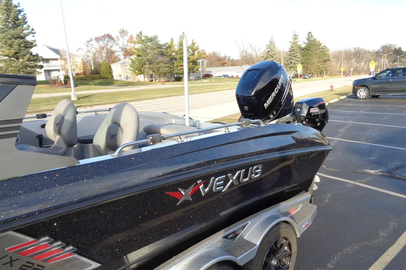 Slide: The Image of 2022 Vexus DVX22 boat with Mercury engine in a parking lot. - 18
