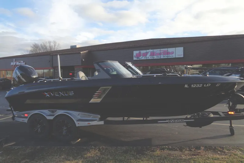 Slide: The Image of 2022 Vexus DVX22 boat on trailer outside a marine dealership. - 20