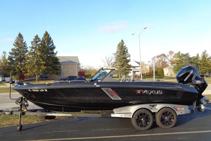 Slide: The Image of 2022 Vexus DVX22 boat on trailer, parked in suburban neighborhood. - 3