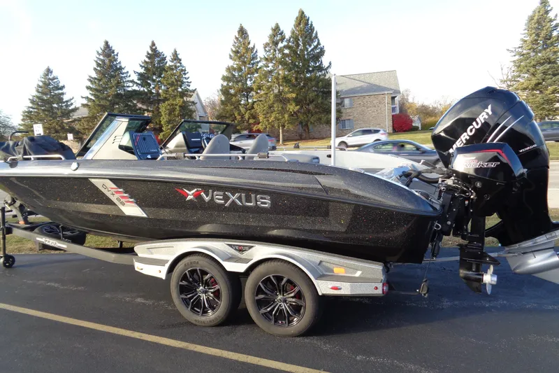 Slide: The Image of 2022 Vexus DVX22 boat with Mercury engine on a trailer, parked outdoors. - 4