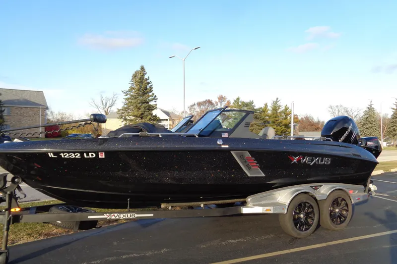 Slide: The Image of 2022 Vexus DVX22 boat on trailer, black exterior, parked outdoors on a sunny day. - 5