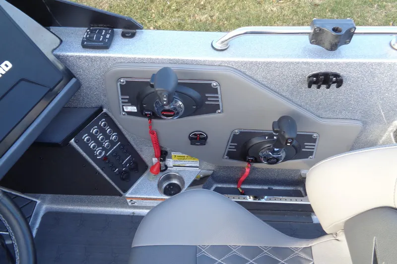 Slide: The Image of 2022 Vexus DVX22 boat control panel with dual throttle levers and switches. - 7
