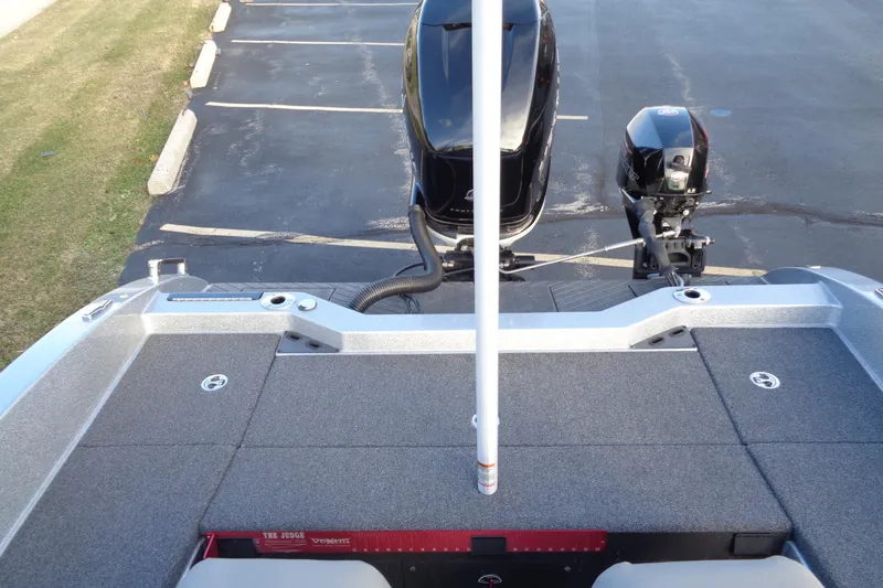 Slide: The Image of 2022 Vexus DVX22 boat rear view with dual motors in a parking lot. - 8