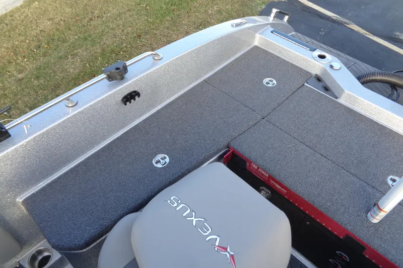 Slide: The Image of 2022 Vexus DVX22 boat interior with gray carpet and seating, showcasing storage compartments. - 9