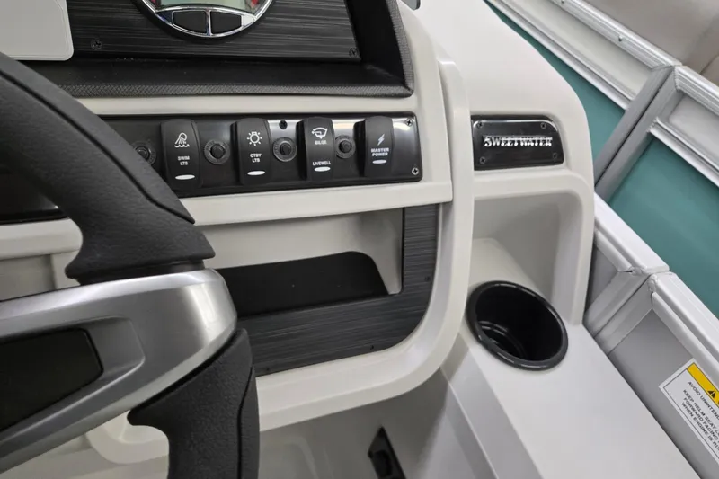 Slide: The Image of 2026 Godfrey Sweetwater 2286 FS dashboard with control switches and steering wheel. - 10