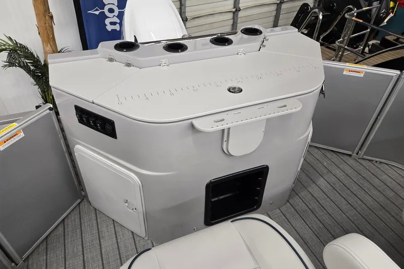 Slide: The Image of 2026 Godfrey Sweetwater 2286 FS boat interior with control panel and seating. - 15