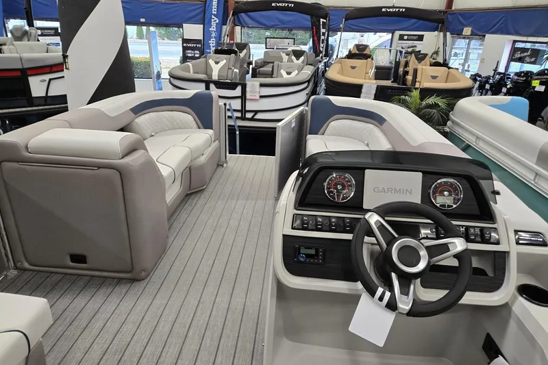 Slide: The Image of 2026 Godfrey Sweetwater 2286 FS pontoon boat interior with Garmin dashboard and plush seating. - 21