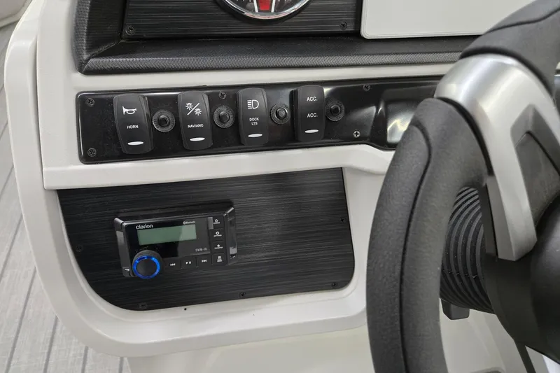 Slide: The Image of Control panel of 2026 Godfrey Sweetwater 2286 FS boat with steering wheel and switches. - 9