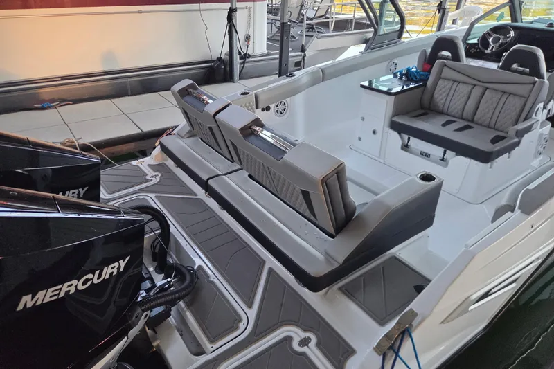 Slide: The Image of 2026 Monterey Elite 30 OB boat interior with Mercury engines, featuring sleek seating and modern design. - 2