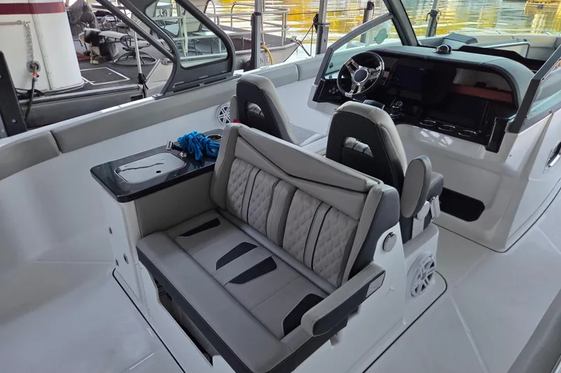Slide: The Image of Interior of 2026 Monterey Elite 30 OB boat with modern seating and steering console. - 3
