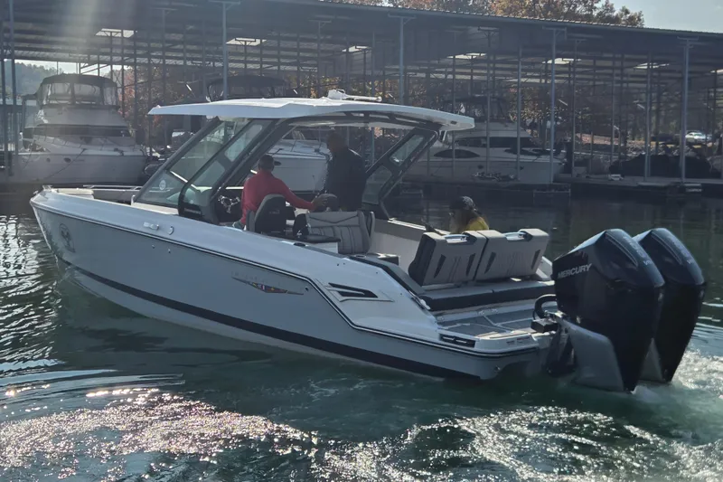 Slide: The Image of 2026 Monterey Elite 30 OB boat with dual Mercury engines in a marina setting. - 5