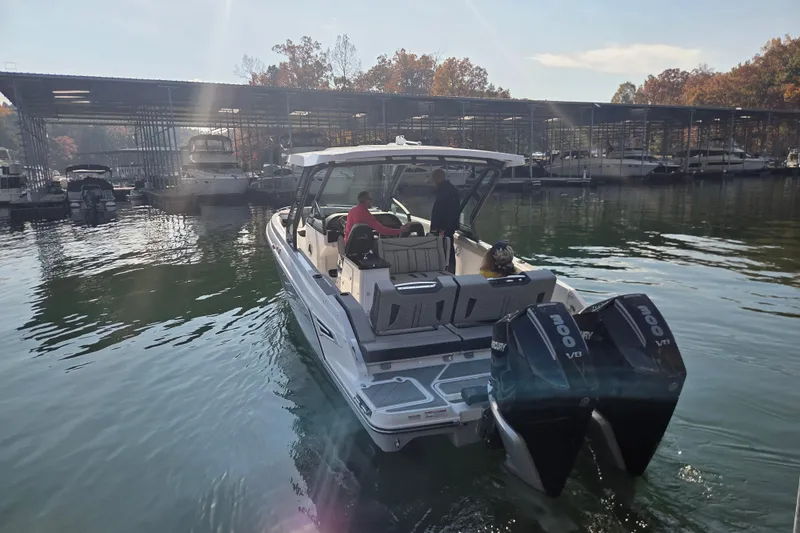 Slide: The Image of 2026 Monterey Elite 30 OB boat docked at marina with twin Mercury engines. - 7