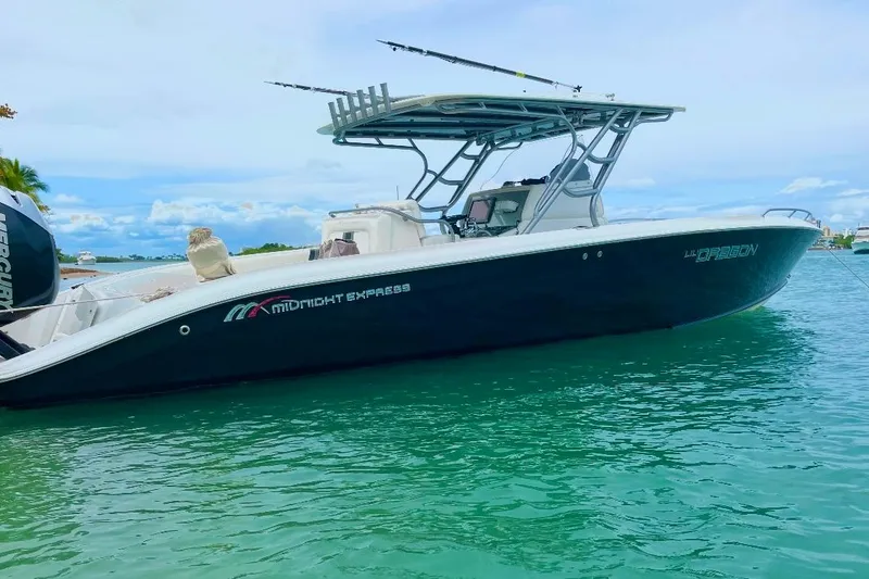 Slide: The Image of 2013 Midnight Express 39S Open boat on turquoise water, side view. - 1