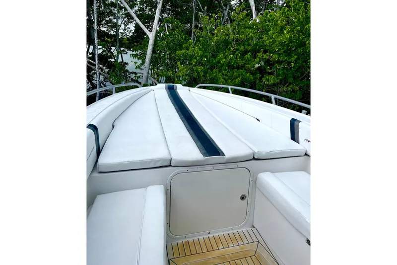 Slide: The Image of 2013 Midnight Express 39S Open boat with white cushioned seating and wooden deck. - 10