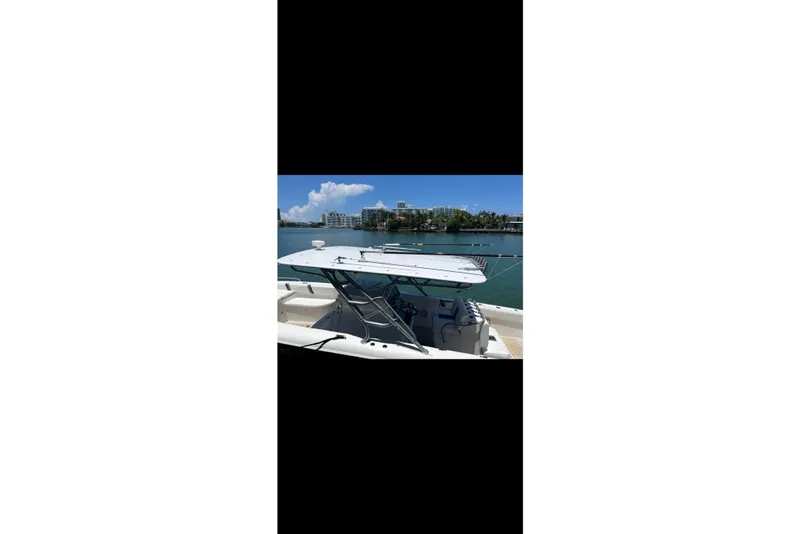 Slide: The Image of 2013 Midnight Express 39S Open boat docked on a sunny waterfront. - 12