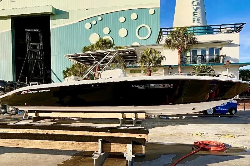 Slide: The Image of 2013 Midnight Express 39S Open boat displayed outdoors on a wooden platform. - 2