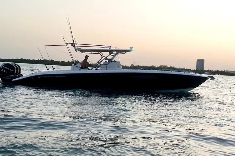 Slide: The Image of 2013 Midnight Express 39S Open boat cruising at sunset on calm waters. - 4