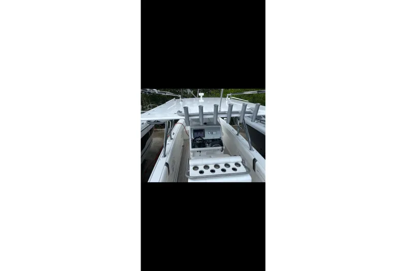 Slide: The Image of 2013 Midnight Express 39S Open boat interior with rod holders and control panel. - 5