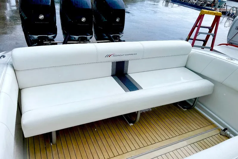 Slide: The Image of 2013 Midnight Express 39S Open boat with white seating and triple Mercury outboard engines. - 7